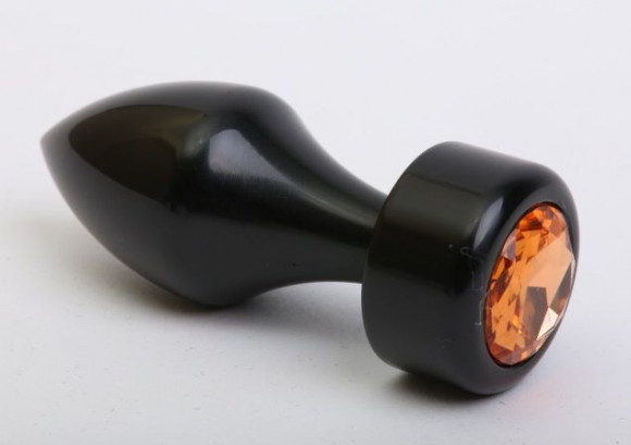 Чёрная анальная пробка с широким основанием и жёлтым кристаллом - 7,8 см. Чёрная анальная пробка с широким основанием и жёлтым кристаллом - 7,8 см.